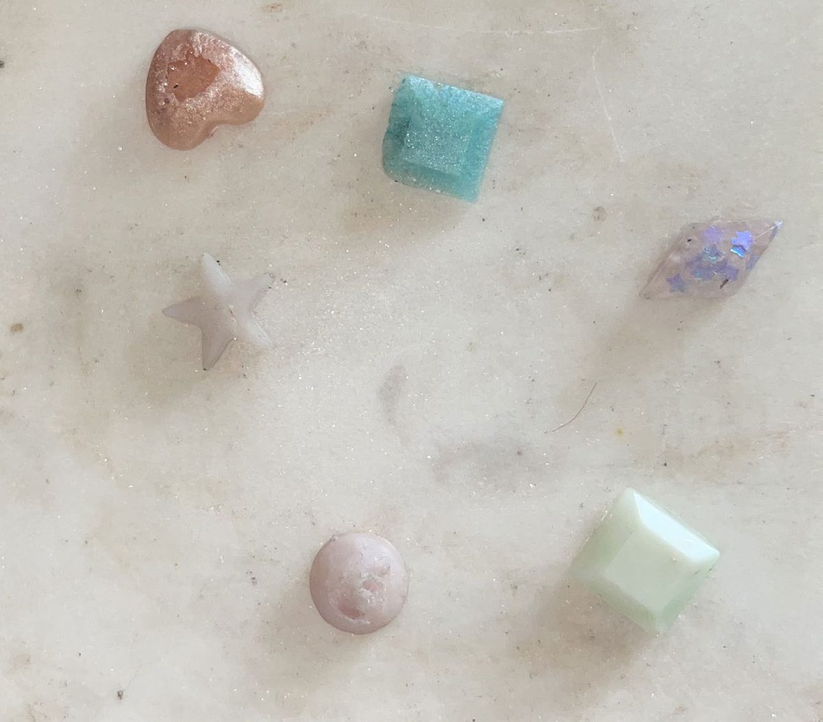 The same UV-resin shapes after sun exposure, partly faded.